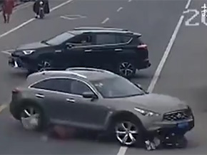 Lexus suv runs over motorcyclist